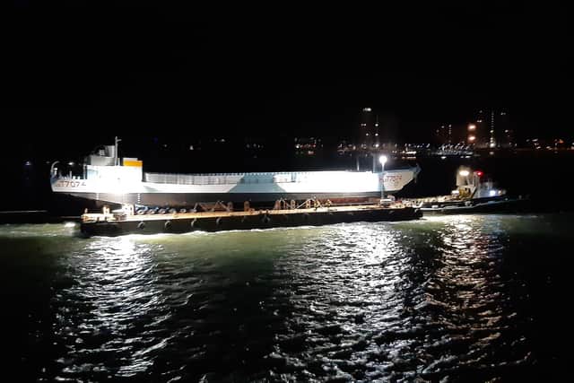 LCT 7074 makes its way past the Round Tower, lighting up the midnight sky. Picture: David George