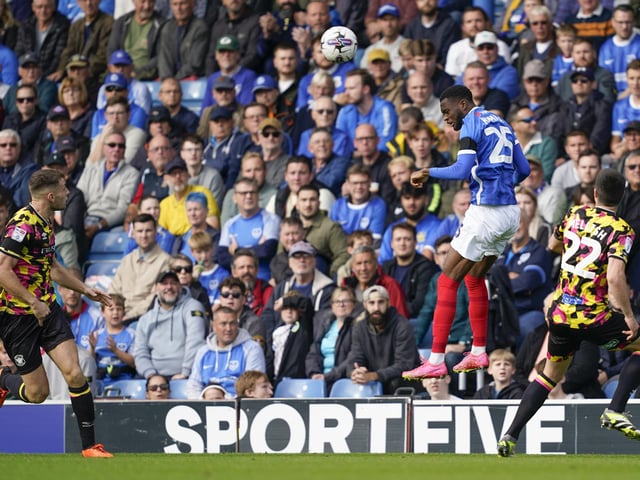 Abu Kamara wins a header under the careful watch of the Fratton faithful