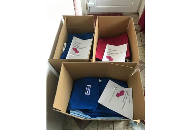 Boxes of scrubs created by sewers from Lin Gell's Facebook group