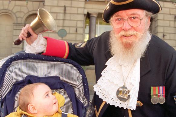 Doncaster Town Crier Ted Corney rings in the New Year, 1997. Photographed with Aaron Robson, 10 months old.