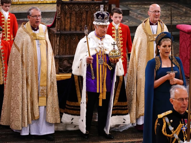 Lord President of the Council, Penny Mordaunt, holding the Sword of State walking ahead of King Charles III during his coronation ceremony in Westminster Abbey, London.