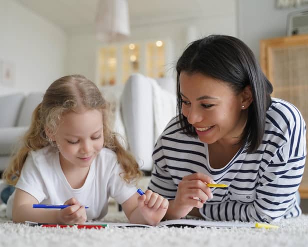 Smiling young mom and little foster daughter painting together: Image posed by models Picture: Adobe Stock