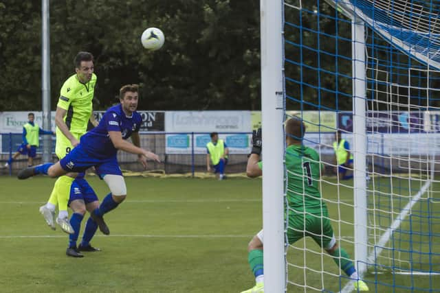 Jason Prior, left, scores for Dorking in a pre-season friendly win against Baffins Milton Rovers. Picture: Mike Cooter