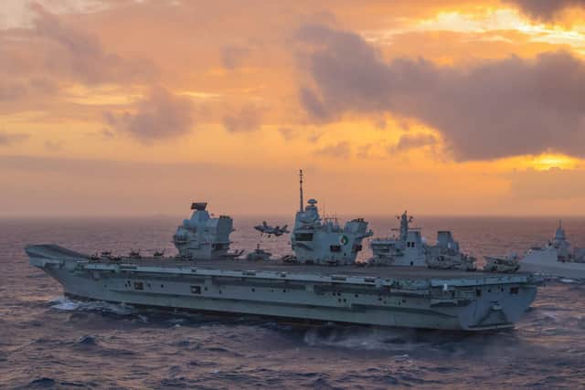 Pictured: An F-35B Jet lands back on HMS Queen Elizabeth whilst she conducts a double replenishment with RFA Tidespring and HNLMS Evertsen in the South China Sea. Photo: Royal Navy