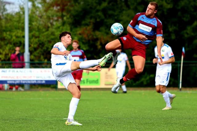 Gosport midfielder Danny Hollands, left, in FA Cup action at Hamworthy. Picture by Tom Phillips