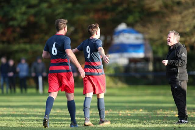 Danny Lane celebrates in front of Bush Hill manager Eugene McManus. Picture: Chris Moorhouse