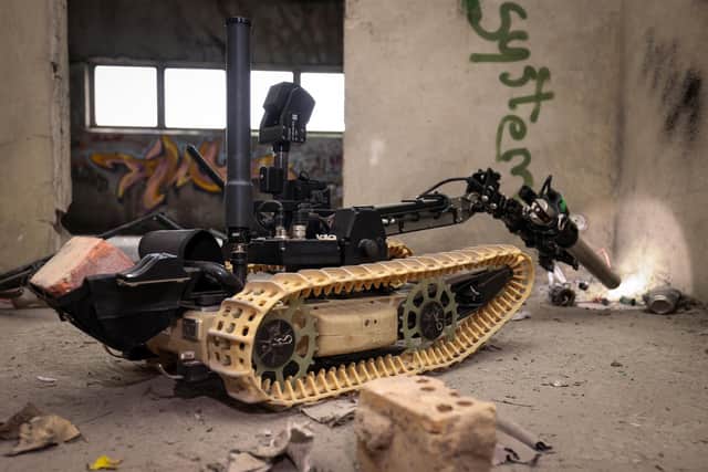 Pictured: A Dragon Runner robot searches a building for an IED.