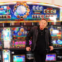 Paul Cook, founder of The Professionals, taking a break between shots for a music video in the arcade on South Parade Pier. Picture by Paul Windsor