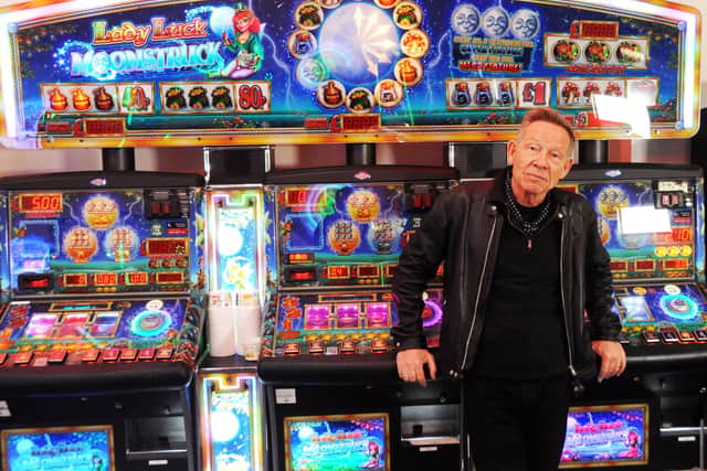 Paul Cook, founder of The Professionals, taking a break between shots for a music video in the arcade on South Parade Pier. Picture by Paul Windsor