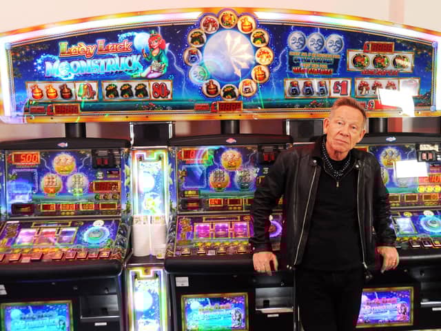 Paul Cook, founder of The Professionals, taking a break between shots for a music video in the arcade on South Parade Pier. Picture by Paul Windsor