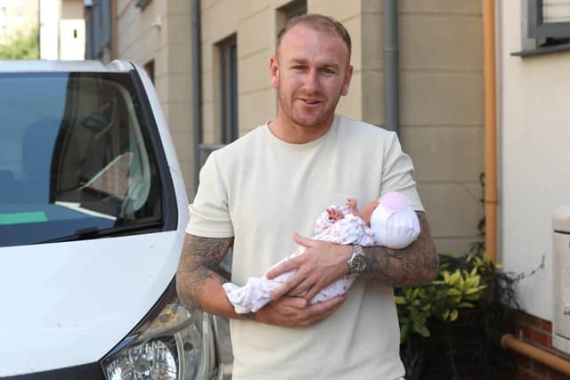 Perry Ryan helped deliver a baby when mum Khan Shoker, 30, had her waters break whilst he was delivering a package. Perry is pictured with baby Bella, 4 days old. Picture: Sam Stephenson.