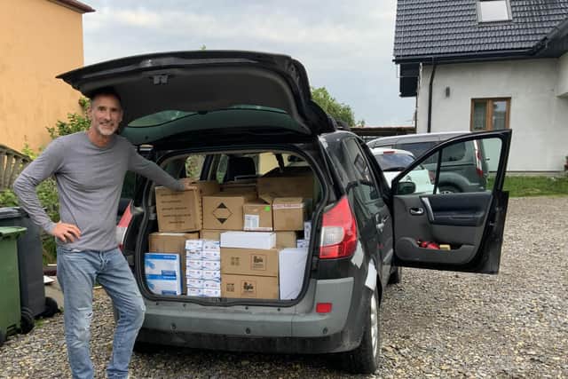 Graeme Warnell receiving the donated phones in Poland.