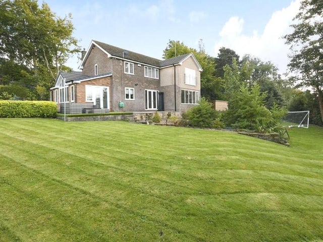 This view from the back shows the property towering above the land it sits on. It also gives you a good idea of the size of the garden.