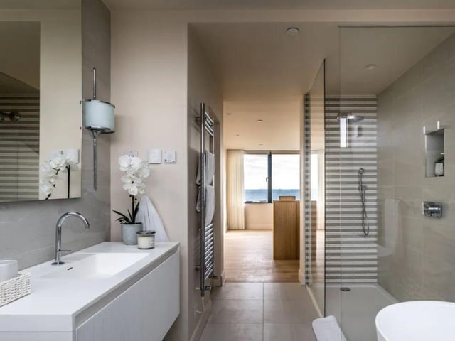 This property comes with four bedrooms, four bathrooms and three reception rooms.