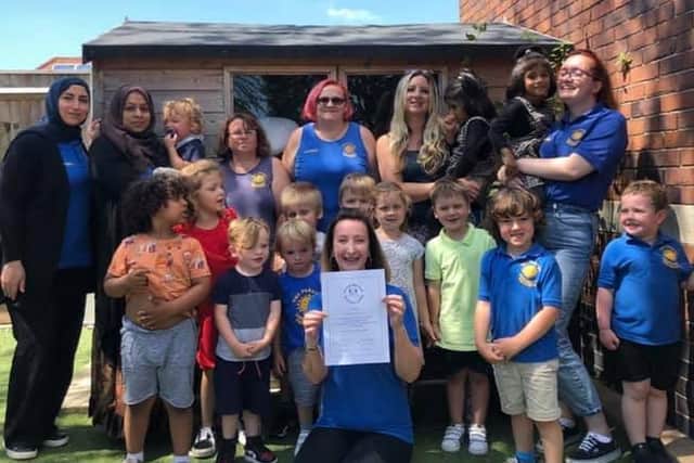 Cathy Robinson (front) with staff and children at Parade Community Pre-school. The nursery is celbrating 20 years of serving the local community.