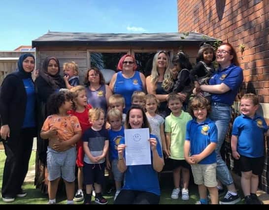 Cathy Robinson (front) with staff and children at Parade Community Pre-school. The nursery is celbrating 20 years of serving the local community.