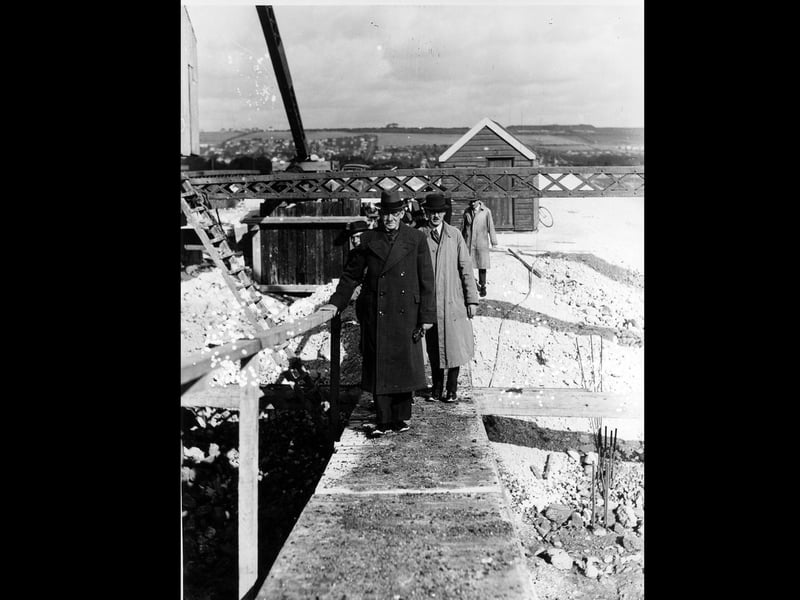 Businessmen walking across the construction site on Eastern Road in 1938. The News PP5297