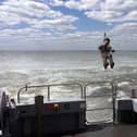Lieutenant Commander AJ Pearson, of 824 Naval Air Squadron, was carefully lowered onto the 58ft-long survey boat in an historic first.