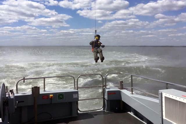 Lieutenant Commander AJ Pearson, of 824 Naval Air Squadron, was carefully lowered onto the 58ft-long survey boat in an historic first.