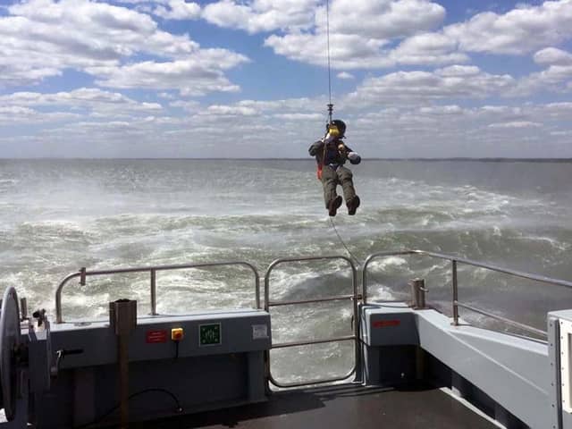 Lieutenant Commander AJ Pearson, of 824 Naval Air Squadron, was carefully lowered onto the 58ft-long survey boat in an historic first.