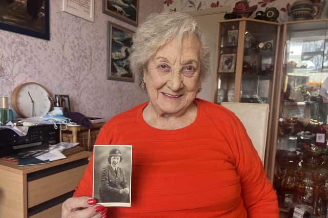Irene Strange of Southsea holding a picture of herself in WRAF uniform in 1951
Picture: Noni Needs