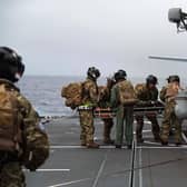The casualty is transferred to a Merlin helicopter for the flight to HMS Queen Elizabeth