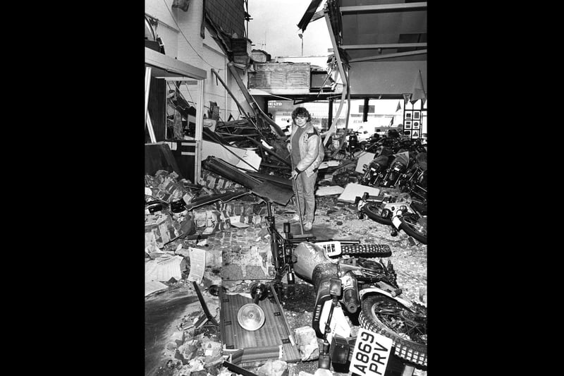 Office worker Carse Louth clears rubble at the Honda Centre, New Road, Portsmouth after it crashed through the roof on to the new motorcycles in October 1987. The News PP4121