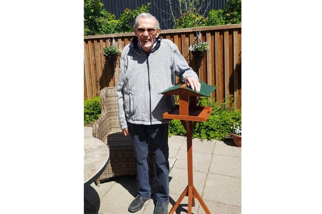 Brian Penn, a resident of Pear Tree Court in Horndean, with the bird table made by volunteers