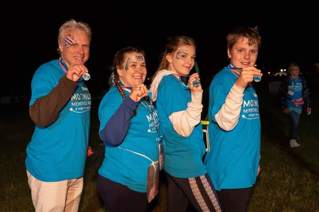 Moonlit Memories Walk 2019 for Rowans Hospice along the Seafront and Old Portsmouth - Pictured Chris Norris with Holly, Hannah and Owen Jordan-Norris show off their medals. Picture: Vernon Nash (160619-044)