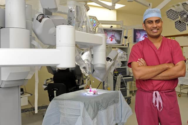 Surgeon Jim Khan pictured with the first Da Vinci robot at QA in 2013.
Pictures: Ian Hargreaves  (132761-4c)