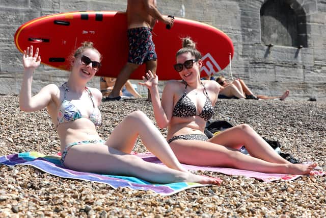 Sunseekers flocked to Portsmouth's beaches on July 18. Pictured is (L-R) Carys Reed, 23, and Lucy Barron, 23, in Southsea. Photo: Sam Stephenson.