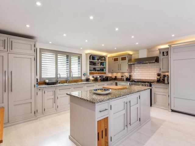 The listing says: "The ground floor consists of a sitting room featuring log burner and under floor heating, huge open plan kitchen dining area, with under floor heating and bi-folds that open up onto the gardens."
