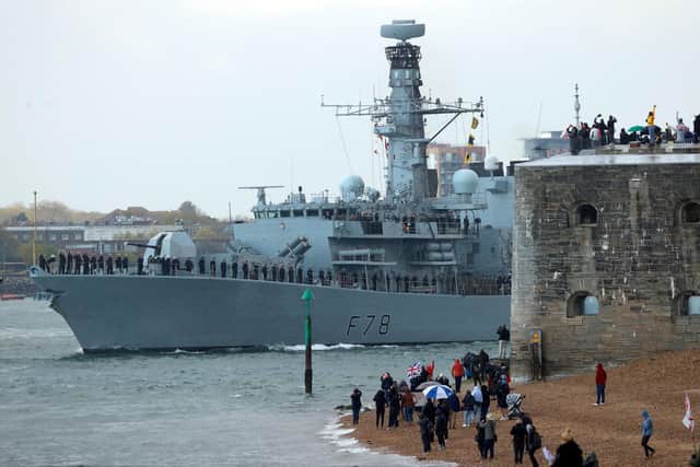 People wave from the shore as HMS Kent, a type 23 frigate, leaves Portsmouth Naval Base on the south coast of England, on May 1, 2021. - The HMS Queen Elizabeth aircraft carrier will leave Portsmouth later to take part in exercises off Scotland before heading to the Indo-Pacific region for her first operational deployment. Accompanied by six royal navy ships, a submarine and carrying eight RAF and 10 US jets she will replace HMS Ocean as the fleet flagship. (Photo by Adrian DENNIS / AFP) (Photo by ADRIAN DENNIS/AFP via Getty Images)