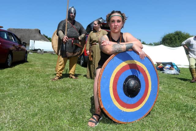 Butser Ancient Farm event sadly cancelled due to a burst water main in the local area. Pictured are Jen Atkinson, (with shield) Tom Tribe and Danielle James packing up to leave the site in the heat.Picture: Sam Stephenson