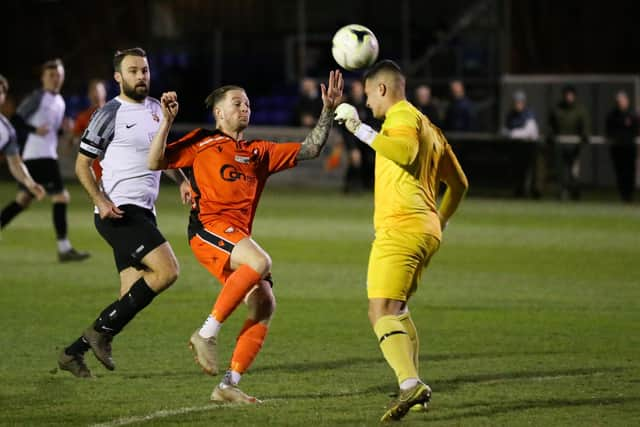 The Pagham goalkeeper heads clear. Picture by Nathan Lipsham