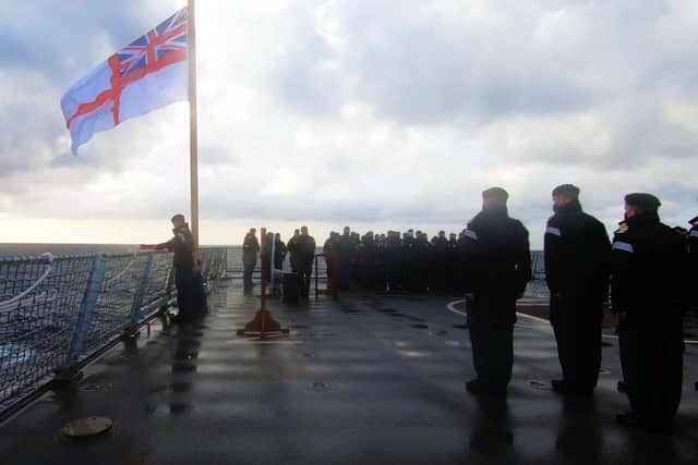 Commander George Storton prepares to place a wreath over the wreck of HMS Ark Royal