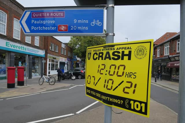 Flowers and a police sign appealing for witnesses have been put in Cosham high street near Vectis Way, where an 85-year-old woman died in a van crash on October 7 2021. Picture: Ben Fishwick