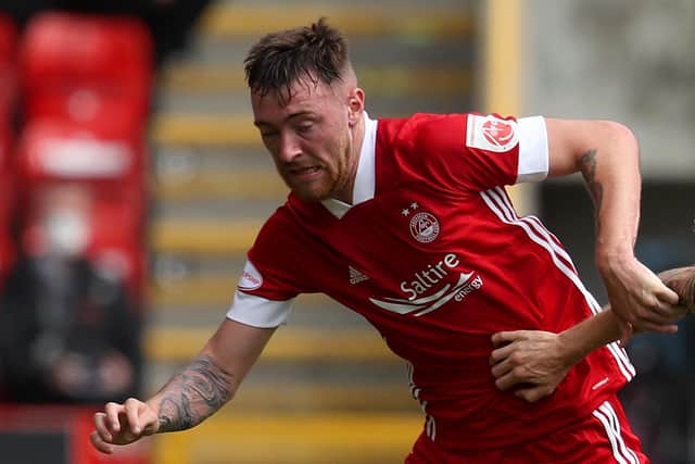 Ryan Edmondson of Aberdeen is challenged by Scott Arfield of Rangers FC during the Ladbrokes Premiership match between Aberdeen and Rangers at Pittodrie Stadium on August 01, 2020 in Aberdeen, Scotland. Football Stadiums around Europe remain empty due to the Coronavirus Pandemic as Government social distancing laws prohibit fans inside venues resulting in all fixtures being played behind closed doors. (Photo by Andrew Milligan/Pool via Getty Images)