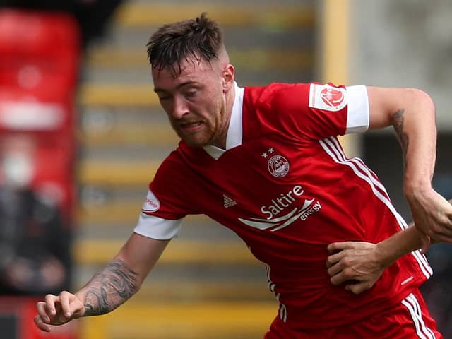Ryan Edmondson of Aberdeen is challenged by Scott Arfield of Rangers FC during the Ladbrokes Premiership match between Aberdeen and Rangers at Pittodrie Stadium on August 01, 2020 in Aberdeen, Scotland. Football Stadiums around Europe remain empty due to the Coronavirus Pandemic as Government social distancing laws prohibit fans inside venues resulting in all fixtures being played behind closed doors. (Photo by Andrew Milligan/Pool via Getty Images)