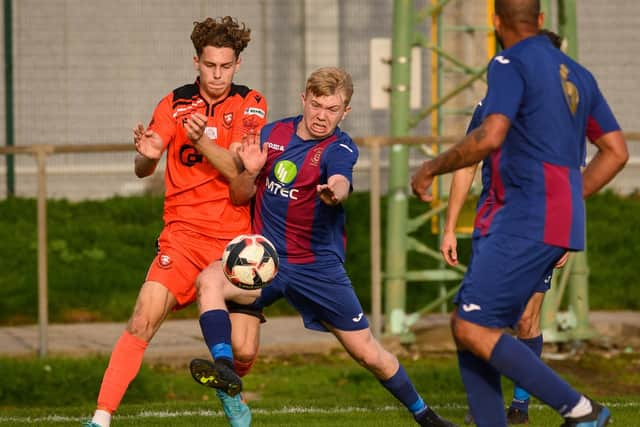 Portchester's Harrison Brook (left) tussles with United Service' Vinnie McGee last month in a 3-1 win in which the ex-Pompey youngster scored. Picture: Keith Woodland (151021-856)