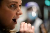 A woman takes the lateral flow test on February 22 at the Guildhall test site in Portsmouth. (Photo by Finnbarr Webster/Getty Images)