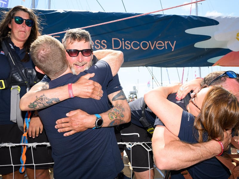 Crew members hug and greet family and friends at the end of the racePicture: Keith Woodland (270721-89)