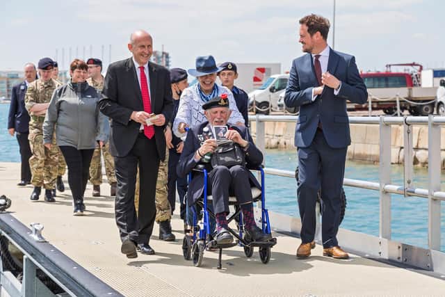 D-Day veteran Joe Cattini (98) entertains John Healey (Shadow Secretary of State for Defence) and Stephen Morgan (Shadow Armed Forces Minister) with his stream of stories at Portsmouth Naval Base on Armed Forces Day. Picture: Mike Cooter (250621)