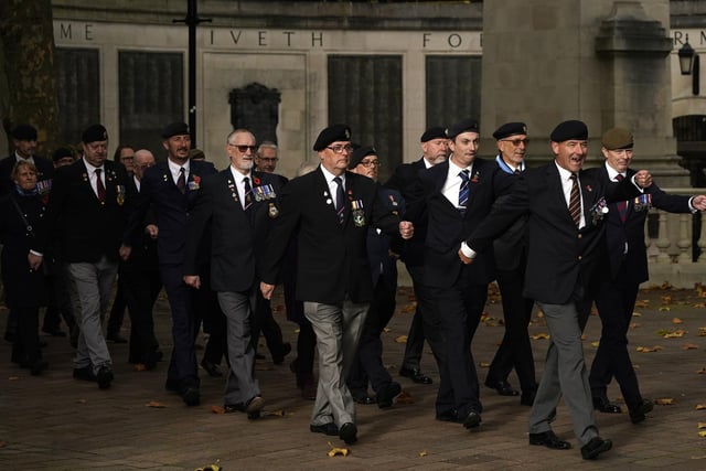 Veterans return from the City of Portsmouth War Memorial towards Guildhall Square