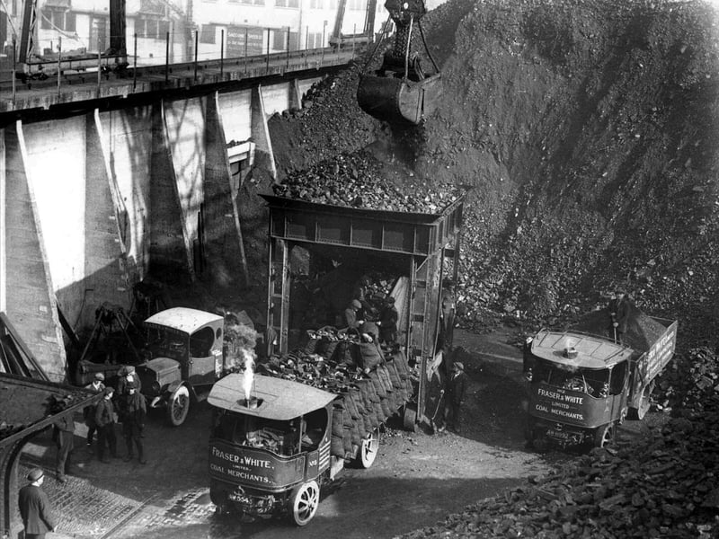 Inside one of the coal hoppers at the Camber, Old Portsmouth. Unloaded from a collier and then loaded on to lorries sometime in the 1940's /50's.
The coal is being loaded into a smaller hopper so that the coalmen can load their sacks seen on the back of the steam lorry. A fascinating scene of times past when every house in the city was coalfired.
Fraser and White Ltd had their head office at Town Quay, Old Portsmouth. Picture: Courtesy of Mick Franckeiss