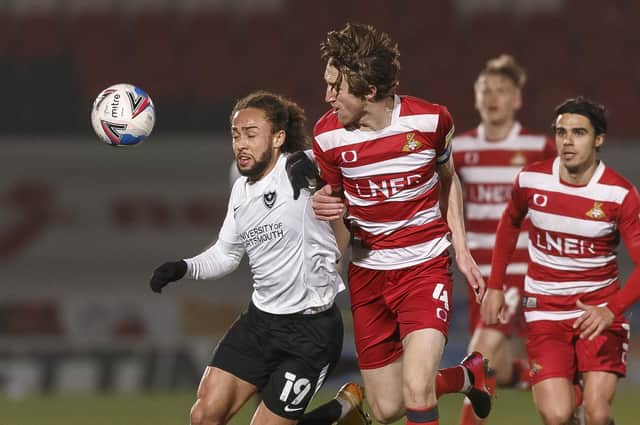 Marcus Harness of Portsmouth and Tom Anderson of Doncaster Rovers during the Sky Bet League One match between Doncaster Rovers and Portsmouth at Keepmoat Stadium on March 2nd 2021 in Doncaster, England. (Photo by Daniel Chesterton/phcimages.com)