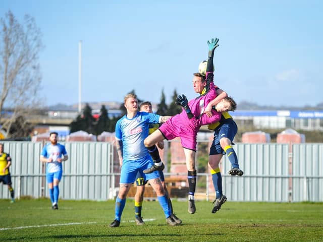 Moneyfields defender Tom Cain challenges the Amesbury goalkeeper. Picture by Dave Bodymore.