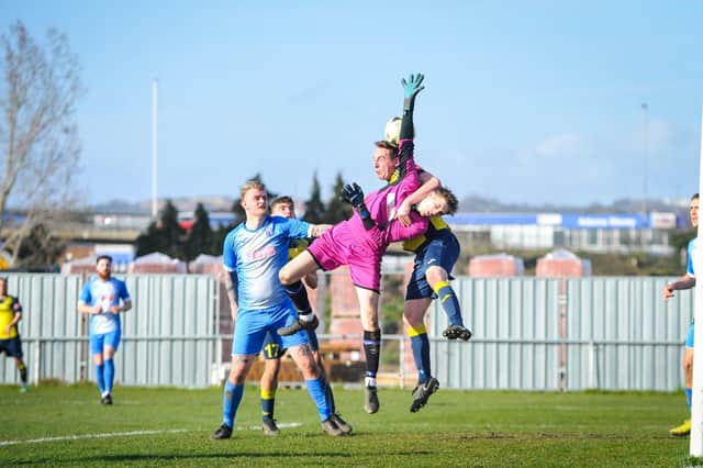 Moneyfields defender Tom Cain challenges the Amesbury goalkeeper. Picture by Dave Bodymore.