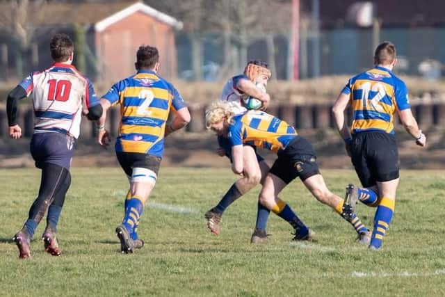 Hat-trick hero Robert Ellis, right, shows another side to his game with a hard-hitting tackle in Gosport & Fareham's win over Sandown & Shanklin Picture: Martin Burnett