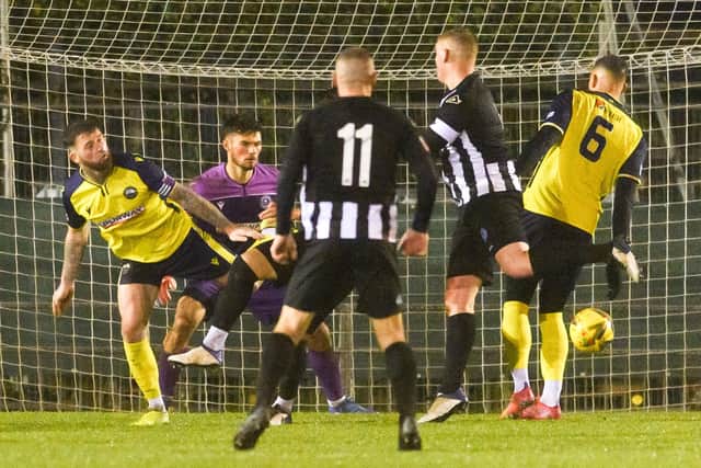 Thiago Da Silva (hidden) heads Dorchester's late leveller at Privett Park.
Picture: Keith Woodland